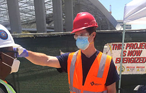 SAVI EHS Screener taking the temperature of an employee coming to work